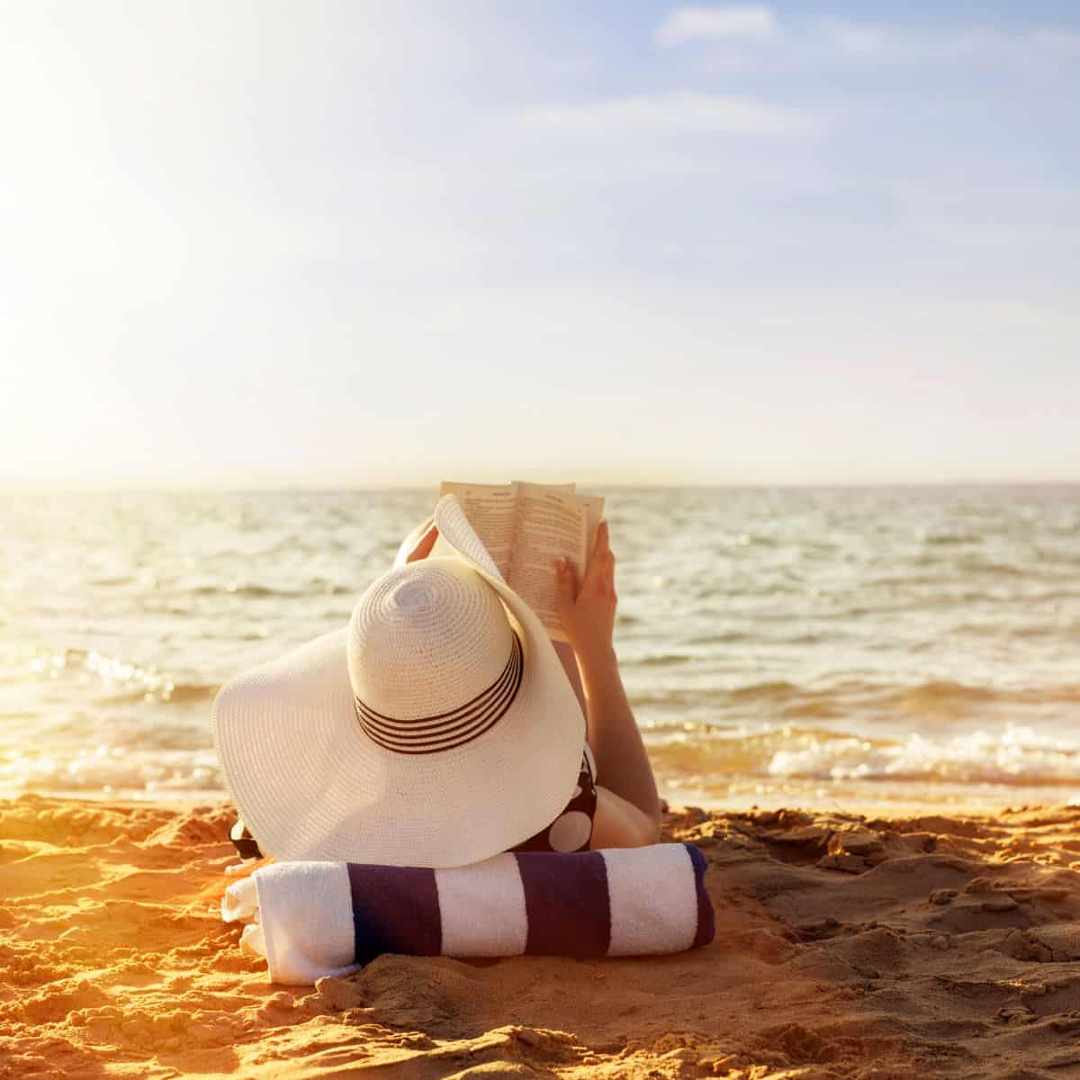 woman reading on beach