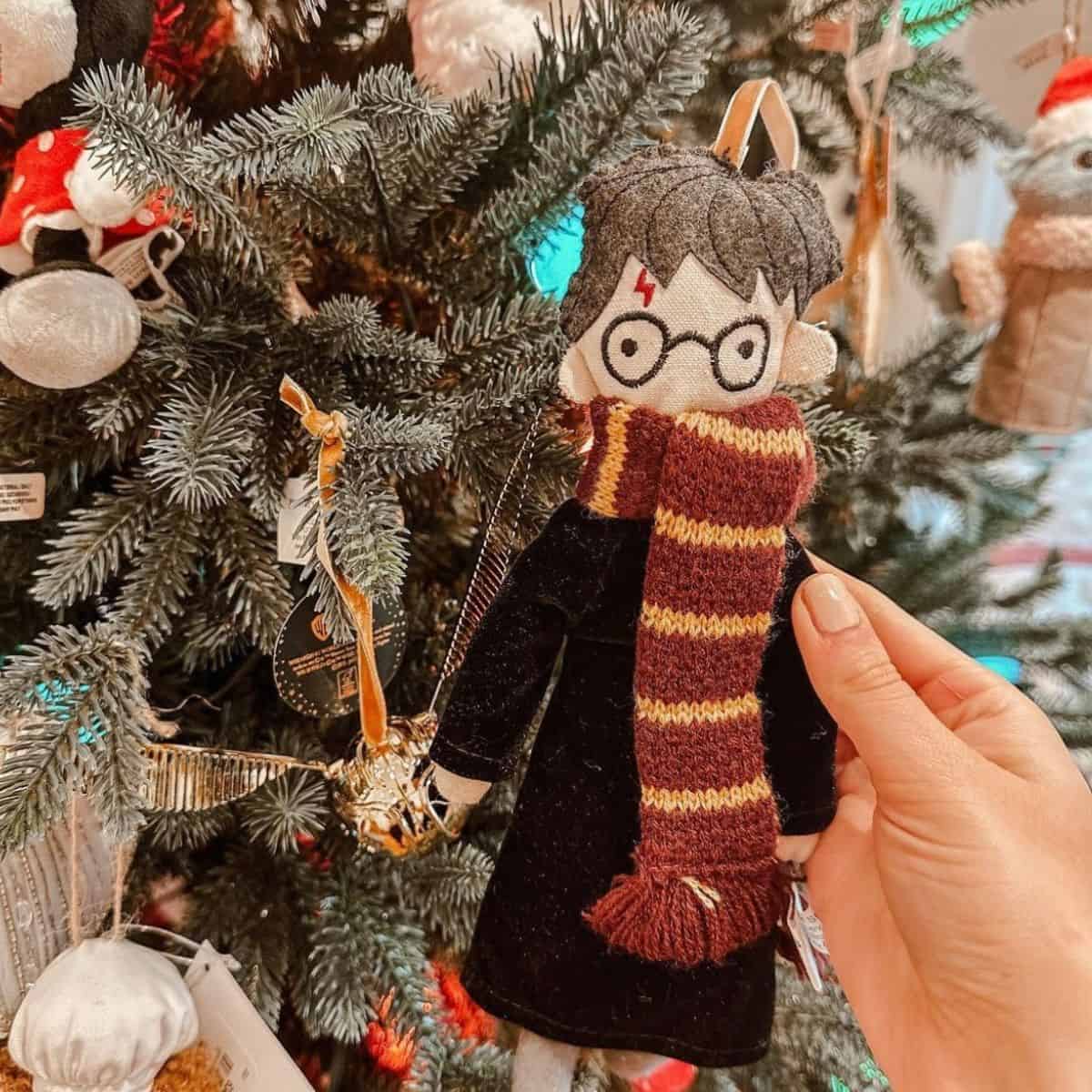 harry potter christmas ornament in front of a tree at pottery barn.