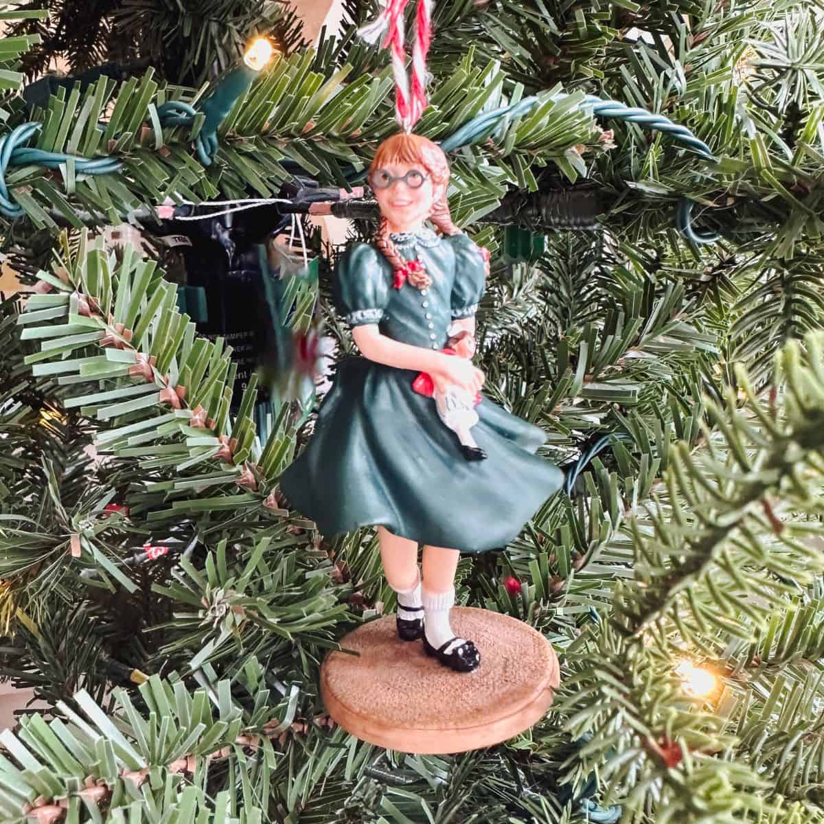 hallmark molly mcintire american girl ornament in front of a tree.