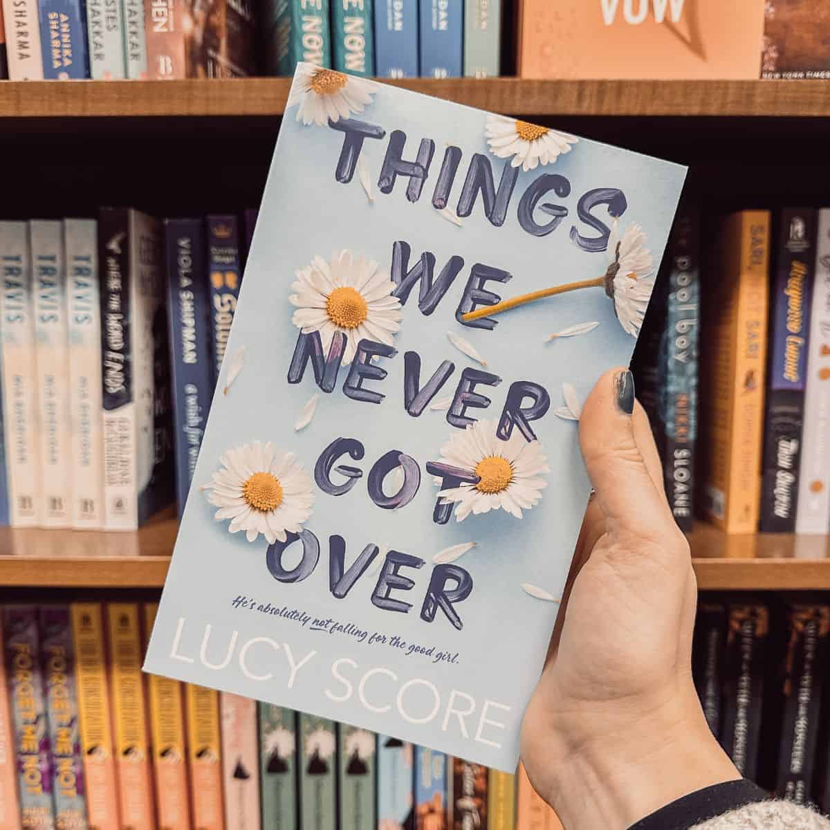 things we never got over by lucy score in front of bookshelves.