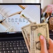 cash in front of a blog on a laptop.