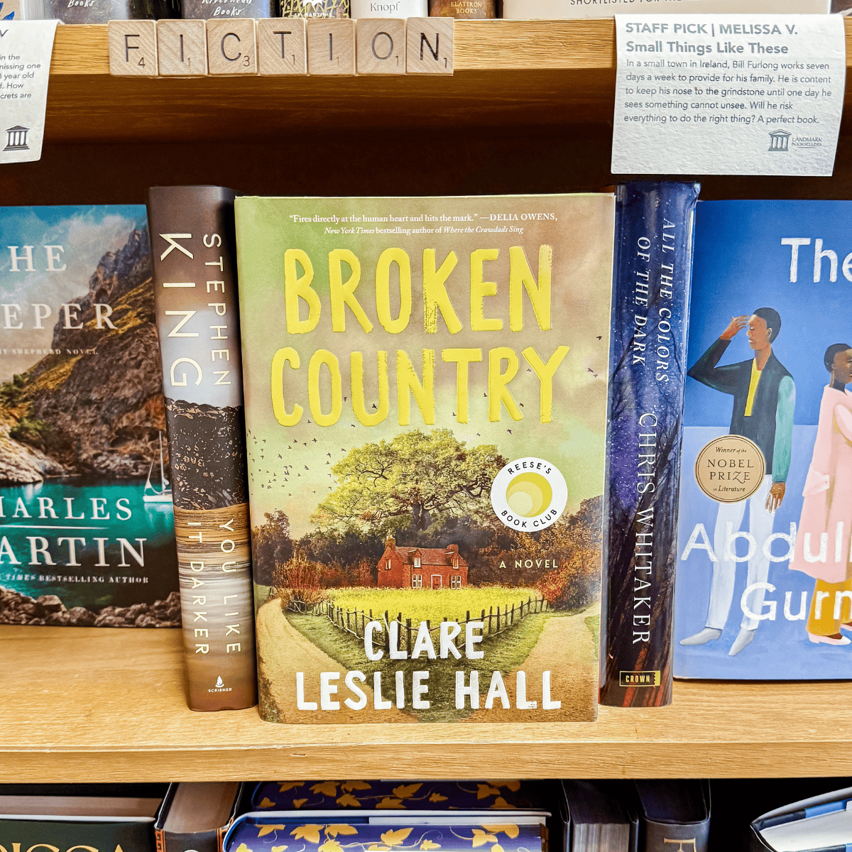 broken country by clare leslie hall in front of a bookshelf.