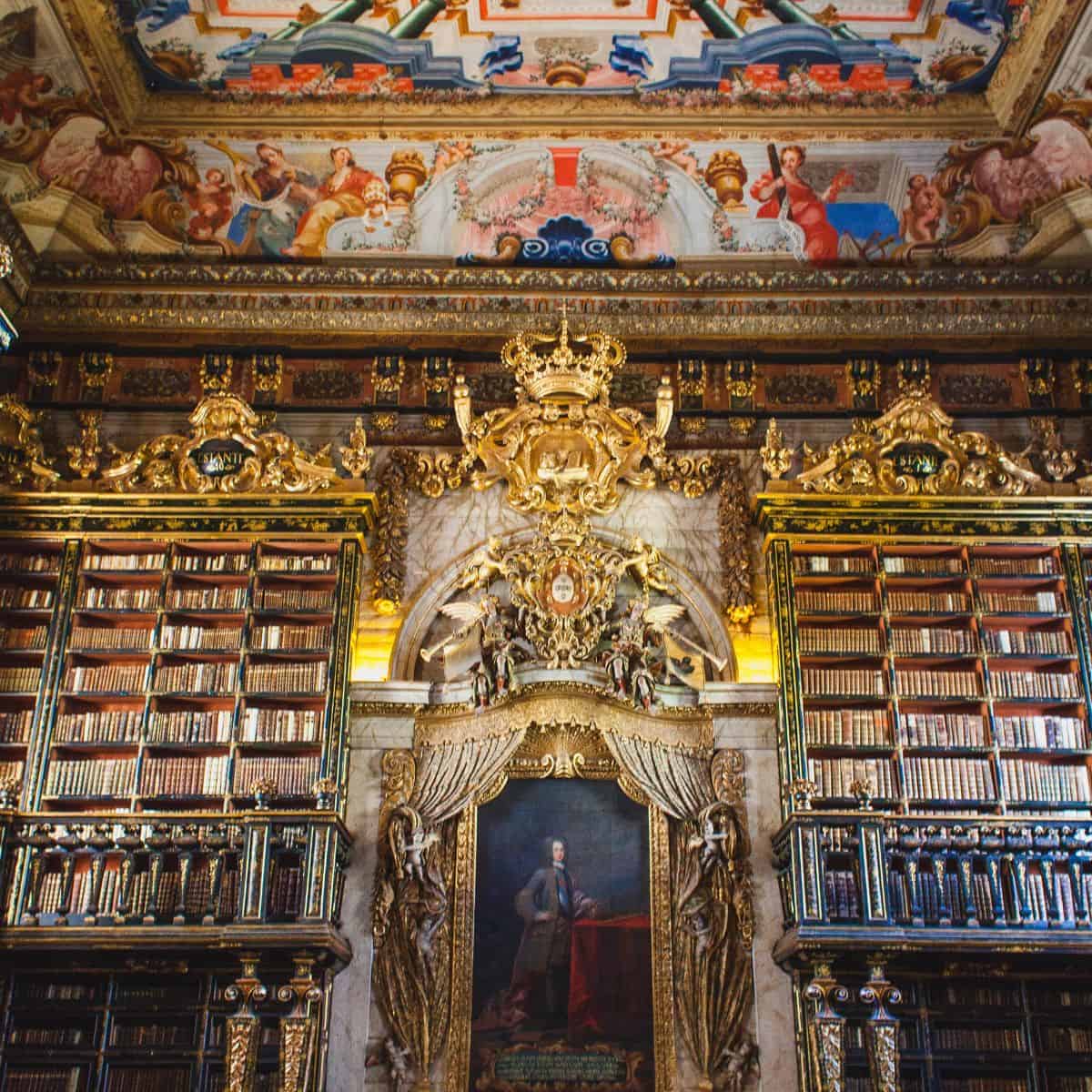 ceiling and bookshelves in biblioteca joanina in portugal.