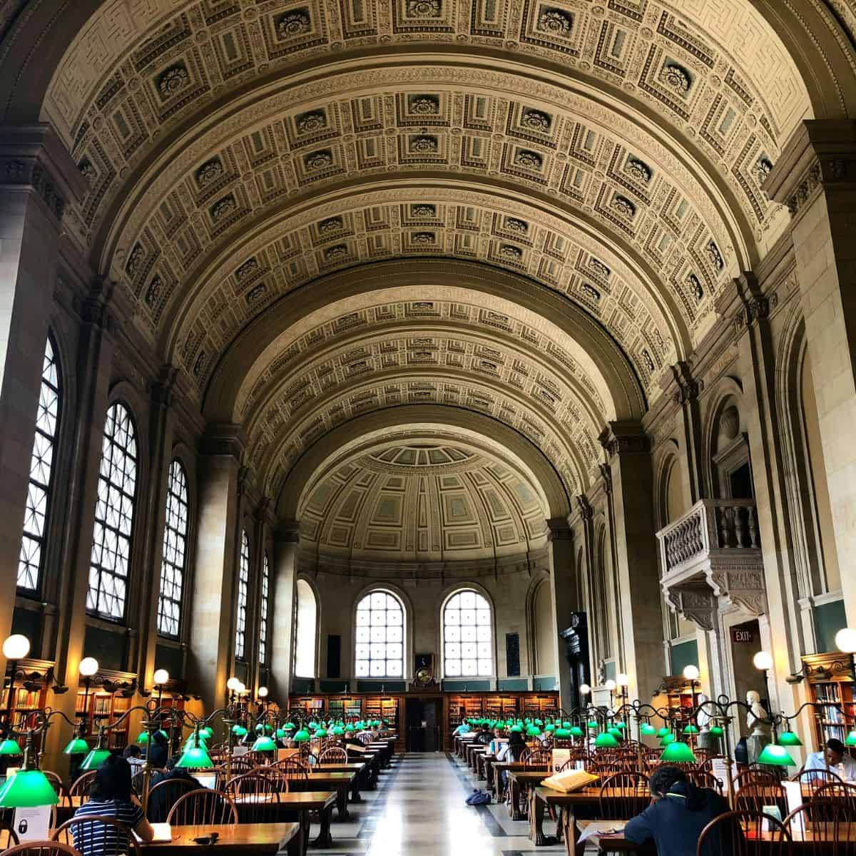 people working at desks in the boston library.
